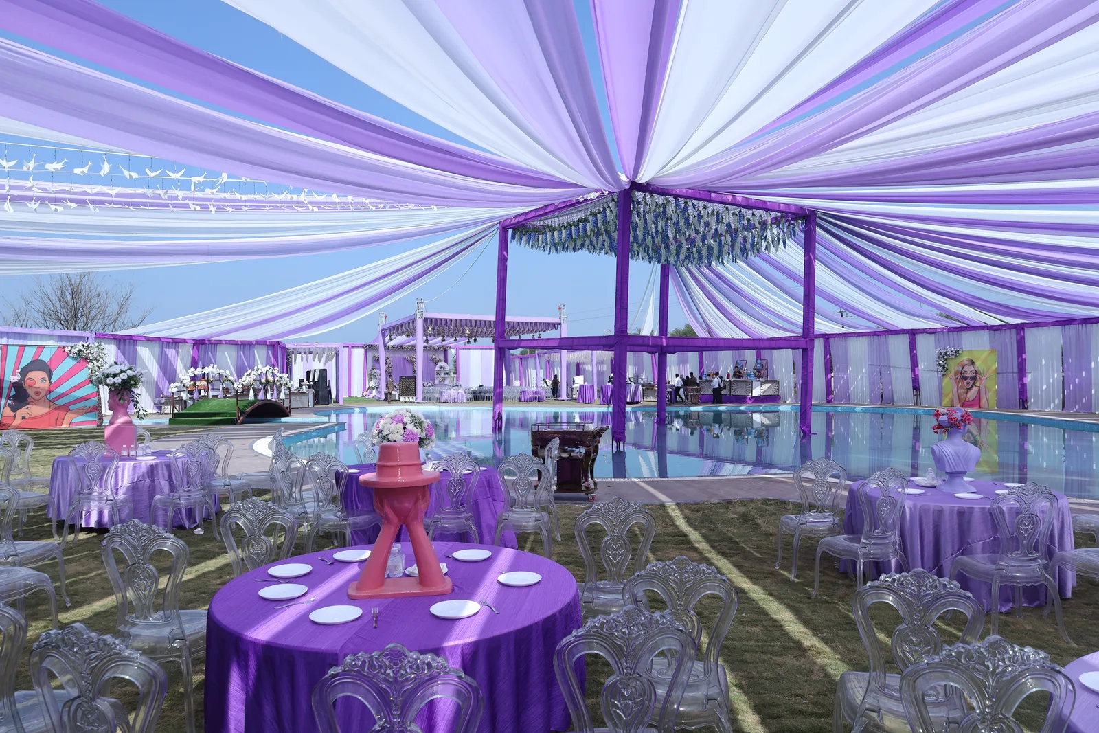 A themed poolside party at Vetiver Grand, Jabalpur: pop-art panels and dressed tables around the lawn pool, built to a client's brief.