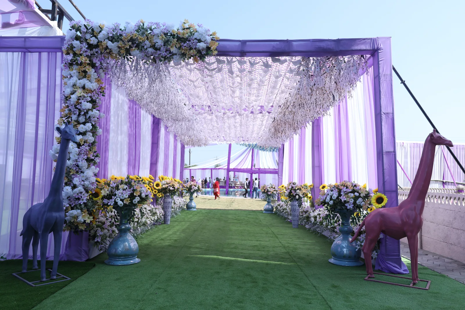 The painted giraffe-statue and floral entrance walkway at Vetiver Grand, Jabalpur, dressed for a wedding event