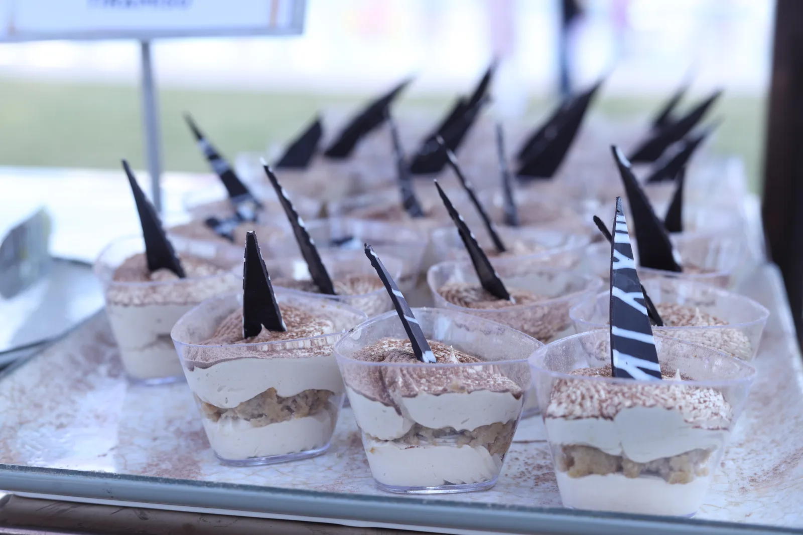 Tiramisu cups finished with dark-chocolate shards: Madhur Milan, Kasturi's sweets counter.